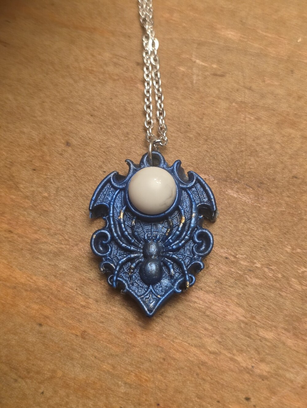 Blue Spider Pendant With White Gemstone On A Solver Tone Chain Necklace